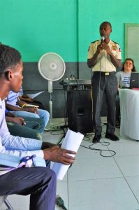 A representative from the community police of Cap-Haitien addresses the gathering 